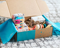 An open Hoppi subscription box filled with high quality toys to support your little one’s development and imagination.